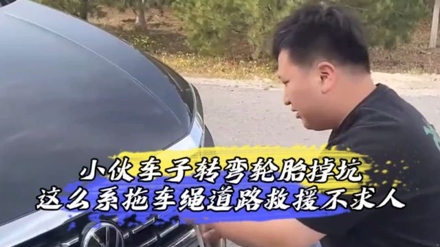 小伙车子转弯轮胎掉坑,这么系拖车绳道路救援不求人?